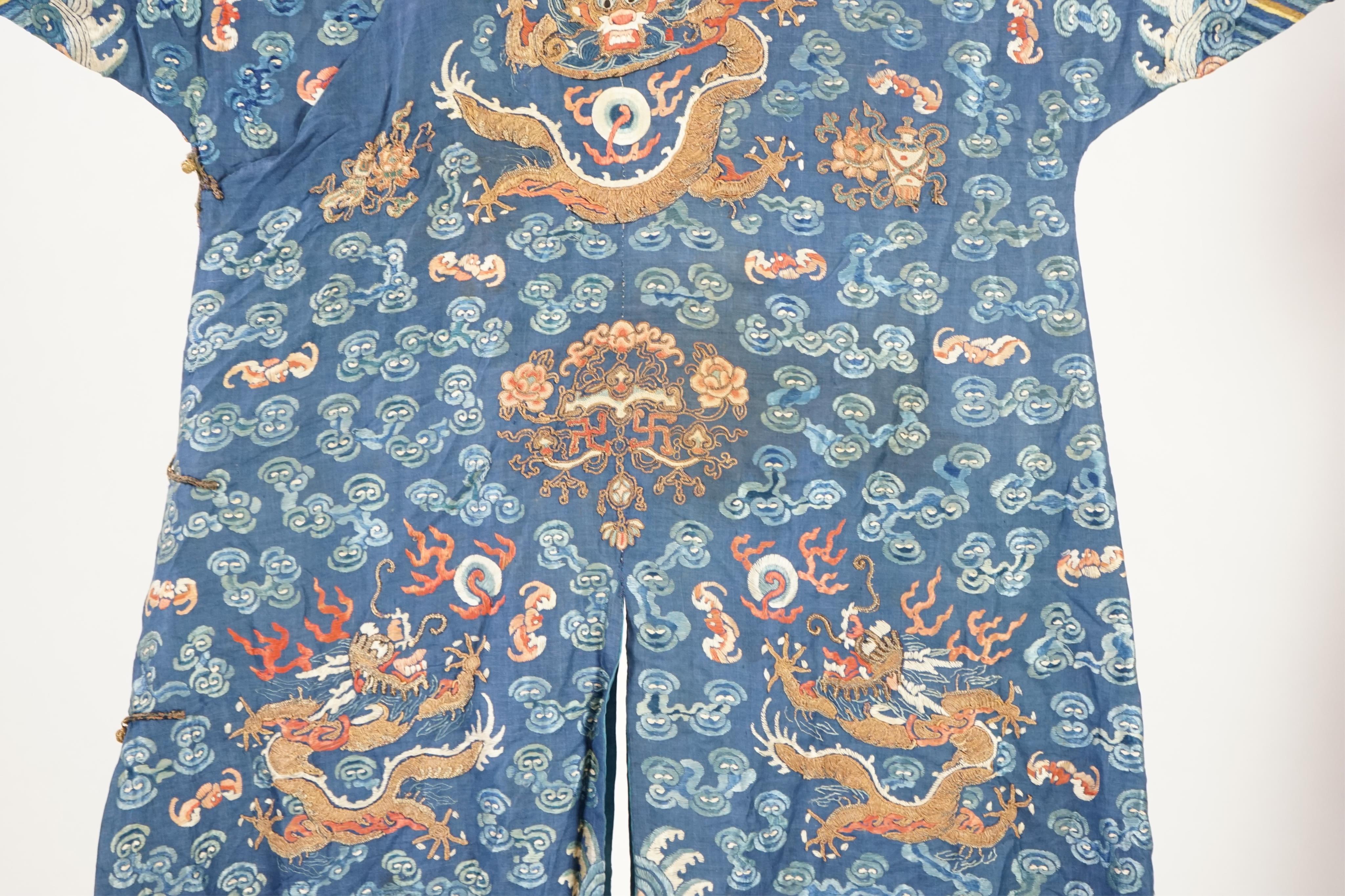 A Chinese blue silk ‘dragon’ robe, jifu, late 19th century and a mandarin hat